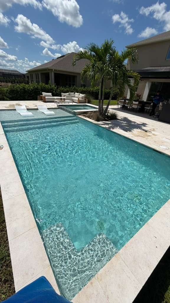Pool with spa and sun shelf, patio furniture