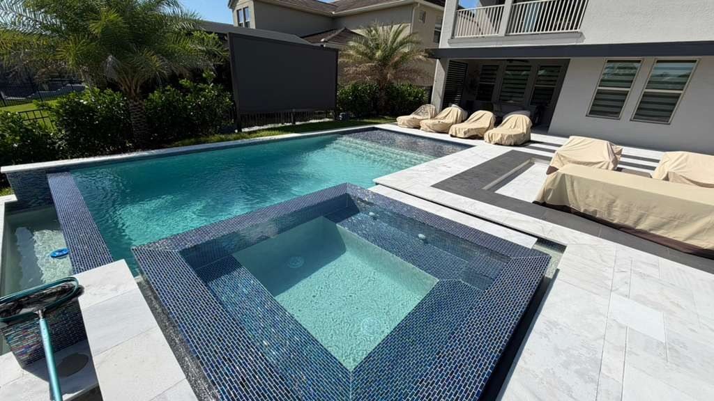 Glass tile spa with covered outdoor furniture